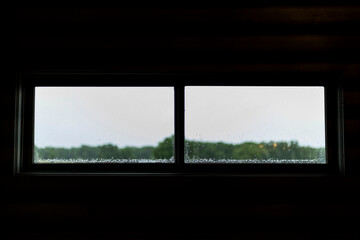 Fototapeta premium Window pane during a rain storm in College Station, TX on May 14th, 2023.