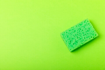 Colorful dish sponges on textured background. Kitchen sponge. Cleaning concept, cleaning service. Dishwashing liquid with clean and dirty dishes plate. Place for text, copy space. Wash the dishes.