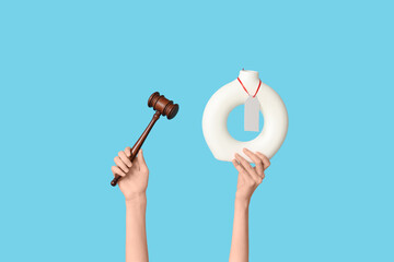 Woman holding auction gavel and antique vase on blue background