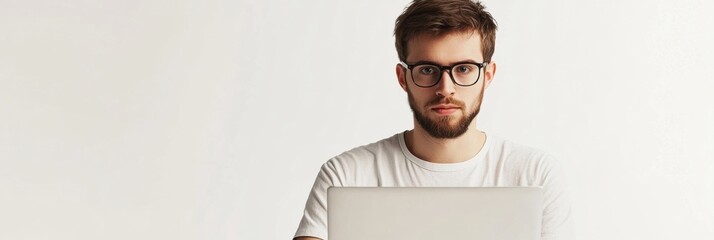 A young man focused on his laptop, embodying the remote work lifestyle with a minimalist white background enhancing productivity. Generative AI