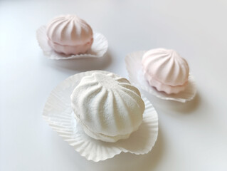 white and pink marshmallow on a gray background
