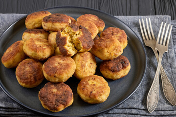 Northern Pike fish cakes on dark grey plate