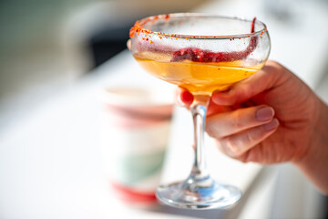 Woman Holding and Drinking a Chili Margarita Cocktail