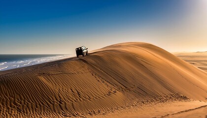 ein gelandewagen fahrt eine hohe namib dune am atlantik herunter sandwich harbour erongo namibia