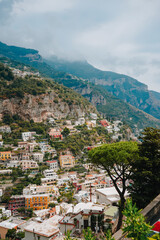 Obraz premium Amalfi coast, Italy. A beautiful Amalfi coast, Positano town with colorful houses on the cliff, green hills, and the Tyrrhenian Sea. Sunny summer day in Positano