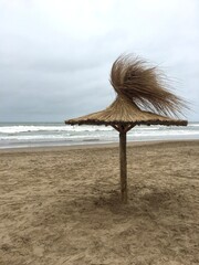 Overcast Day in Cariló with Straw Beach Umbrella