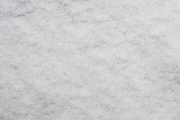 the texture of the first snow, through which the ground is slightly visible
