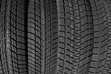 Closeup image of textured pattern of directional tread blocks and large sipes on winter non studded tires
