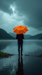 A person stands by a serene lake under an orange umbrella, surrounded by dramatic mountain scenery and moody skies, evoking a sense of solitude and introspection.