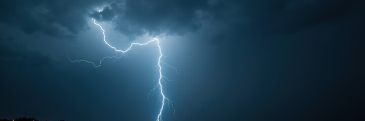A dramatic lightning strike illuminates a dark stormy sky, capturing the power and beauty of nature's forces.