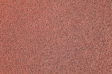 Red rubber floor, texture, background. Relief surface. Faded, old, granular rubber coating and surface with blurry chaotic pattern. Embossed patterns. Abstract elements exterior and interior