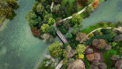 Stunning Aerial View of a Lush Green Park Featuring Bridges and Waterways That Connect Areas