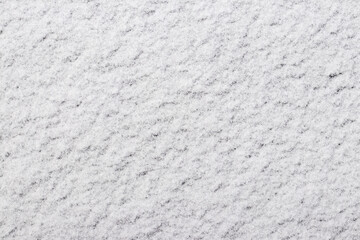 the texture of the first snow, through which the ground is slightly visible