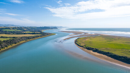 A stunning view from above, where the river and ocean meet during high and low tides.  It's a beautiful natural scene, perfect for a summer day.