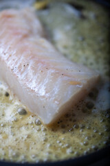 Cod fillet on a skillet.