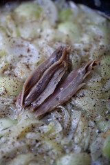 Anchovy and onions are being cooked.