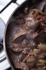 Chicken livers are being cooked with onions.