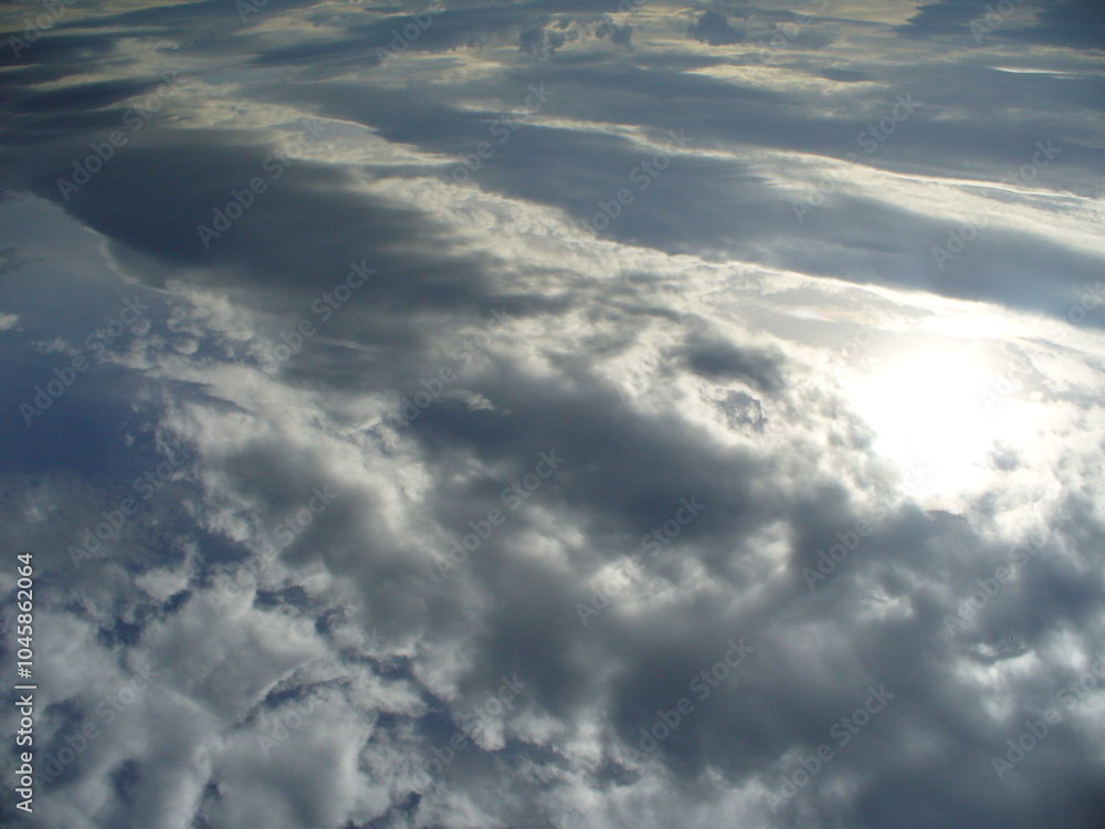 Wall mural cloudy sky, clouds at different heights and sun rays - natural background. topics: sun energy, weath