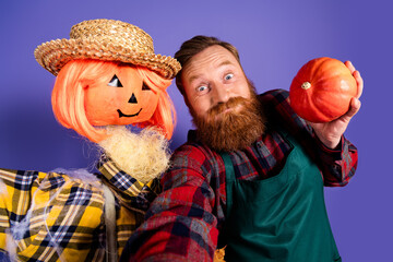 Photo of hilarious man farmer scary scarecrow doll guarding field halloween autumn season festival isolated on purple color background