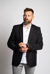 handsome man posing in front grey background