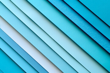 Obraz premium Various shades of blue paper are layered and arranged diagonally, creating a textured composition. The subtle color variations add visual interest, perfect for creative projects or backgrounds.