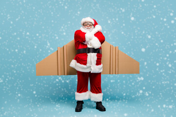Full length body size view of his he nice fat cool content cheerful St Nicholas Santa wearing plane wings fast shipping shop delivery service folded arms isolated over blue pastel color background