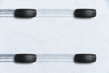 Traces on the road from the invisible car top view tread of winter and car tyres