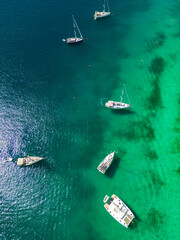 Fototapeta premium Drone top down view on sailing boats anchored in beautiful, crystal clear waters of Rogoznica, Croatia, famous nautical destination in the adriatic sea