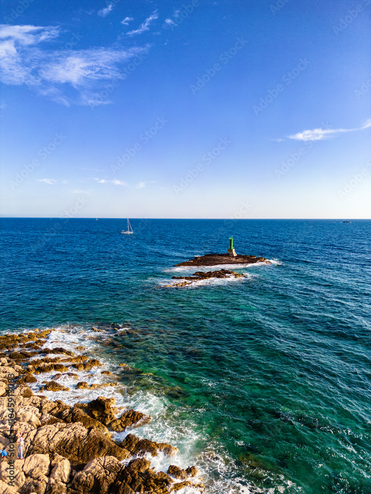 Sticker Aerial view of Punta Planka peninsula with green lighthouse on the island across, place where southern and northern sea currents collide