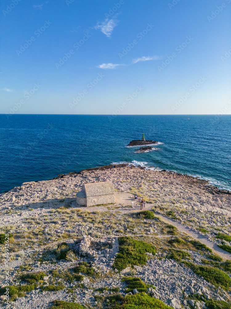 Sticker Drone view of beautiful, rough coast of Punta Planka, Croatia with old, forsaken drywalls and turquoise sea, splashing the sharp rocks