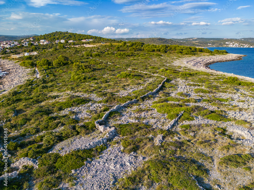 Canvas Prints Drone view of beautiful, rough coast of Punta Planka, Croatia with old, forsaken drywalls and turquoise sea, splashing the sharp rocks