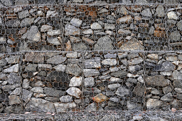View of the gabion walls made of wire netting with granite boulders to prevent landslides