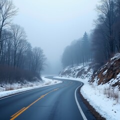 Fototapeta premium A foggy winter road through a snowy forest