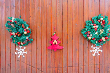 background Christmas wreath with Christmas decorations on a background of wooden boards