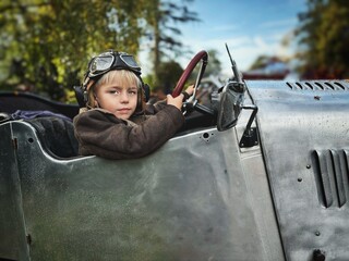 child dressed as a pilot in a car like a plane © Valeriia