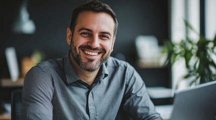 Fototapeta premium Confident Businessman Smiling and Sitting at Desk in Modern Office