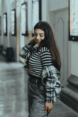 Chic Brunette Posing Near Theater at Night