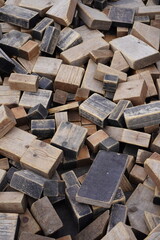 Pile of weathered wooden blocks in various shapes and sizes. Background or backdrop