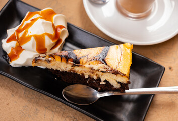 Amazingly delicious sweet cheesecake with brownies and caramel ice cream