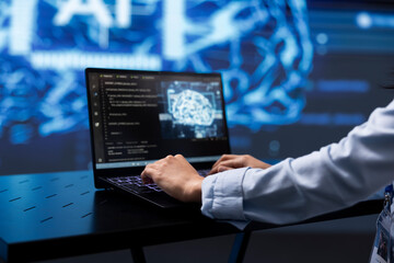 Software developer uses AI cognitive computing to extract information from complex data on laptop. Close up of worker using artificial intelligence on notebook to accelerate complex calculations