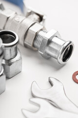 Hydraulic parts and tools lying on a white background (selective focus) studio