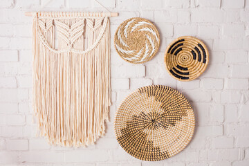 Closeup of three decorative straw plates and a macrame