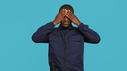 Clueless security guard shrugging shoulders, unable to answer people inquiries. Portrait of...