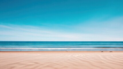 Fototapeta premium A picturesque sandy beach bathed in sunlight, with a gentle wave lapping against the shore and a stunning blue sky overhead