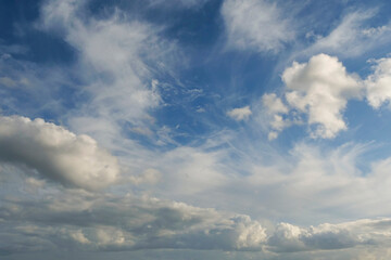 The sky is blue with a few clouds scattered throughout. The clouds are white and fluffy, giving the sky a peaceful and serene appearance