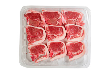 Nine fresh lamb loin chops on a plastic tray. High quality meat product on the bone cut by butcher in perfect size for cooking. Food supply chain and agriculture industry. White background.