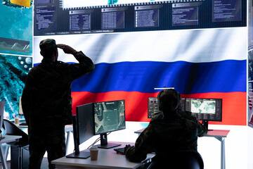 Russian army soldier presenting the official salute in operations room, inflicting propaganda and...