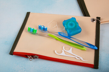 Cosmetic dental care set for travel Green and blue toothbrush and oral dental care products on colorful background, copy space.