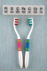 Toothbrushes and daily care on color background