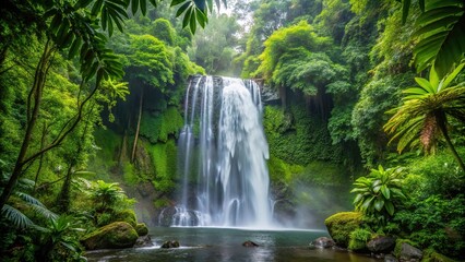 Naklejka premium Waterfall cascading over lush rainforest foliage with droplets visible in mid-air under overcast sky, tilted angle